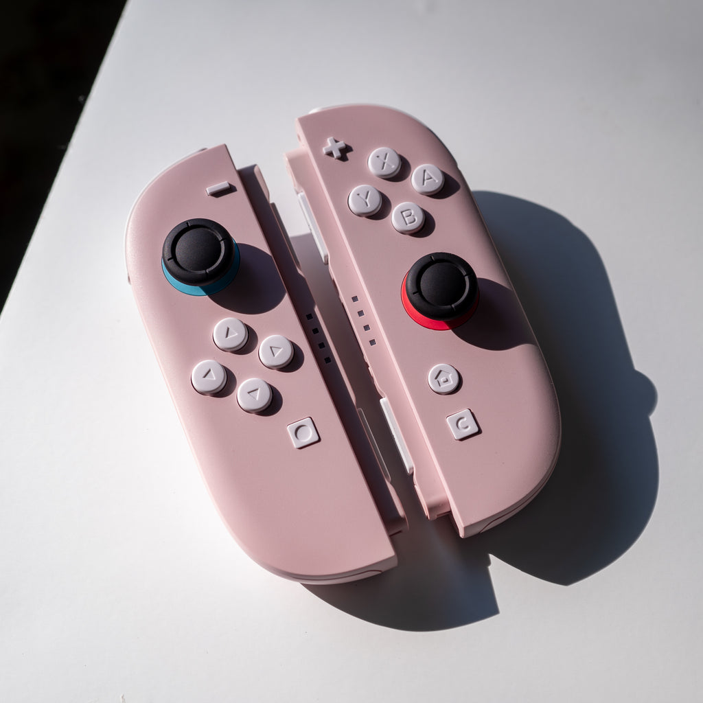 Pink Switch 2 Joy-Cons with custom white buttons.