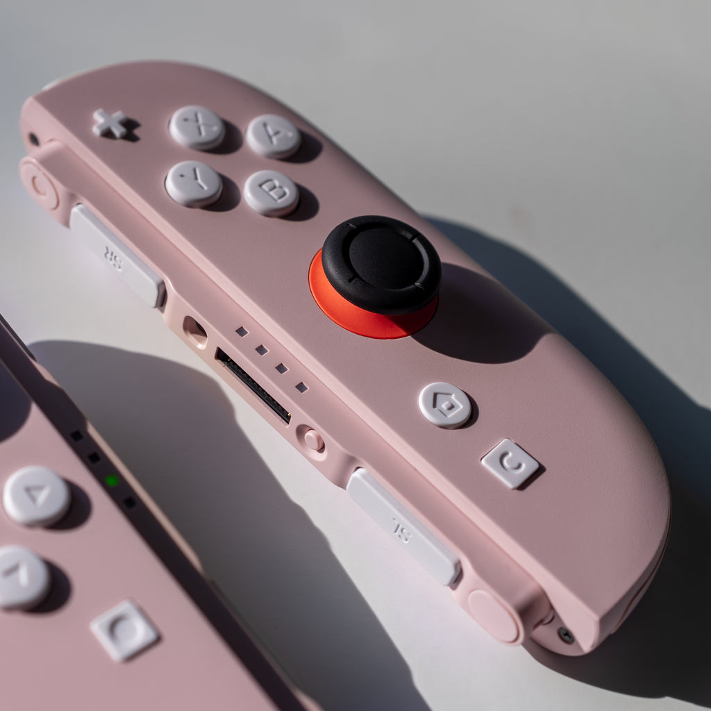Pink Switch 2 Joy-Cons with custom white buttons.