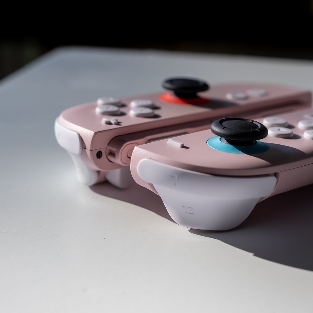 Pink Switch 2 Joy-Cons with custom white buttons.