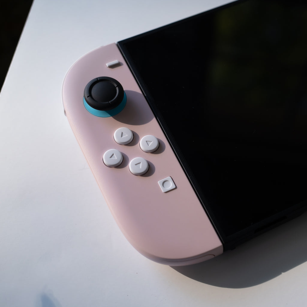 Pink Switch 2 Joy-Cons with custom white buttons.