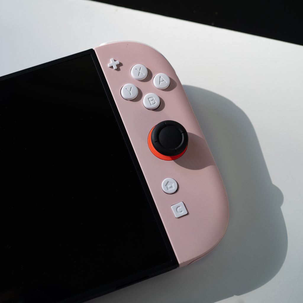 Pink Switch 2 Joy-Cons with custom white buttons.