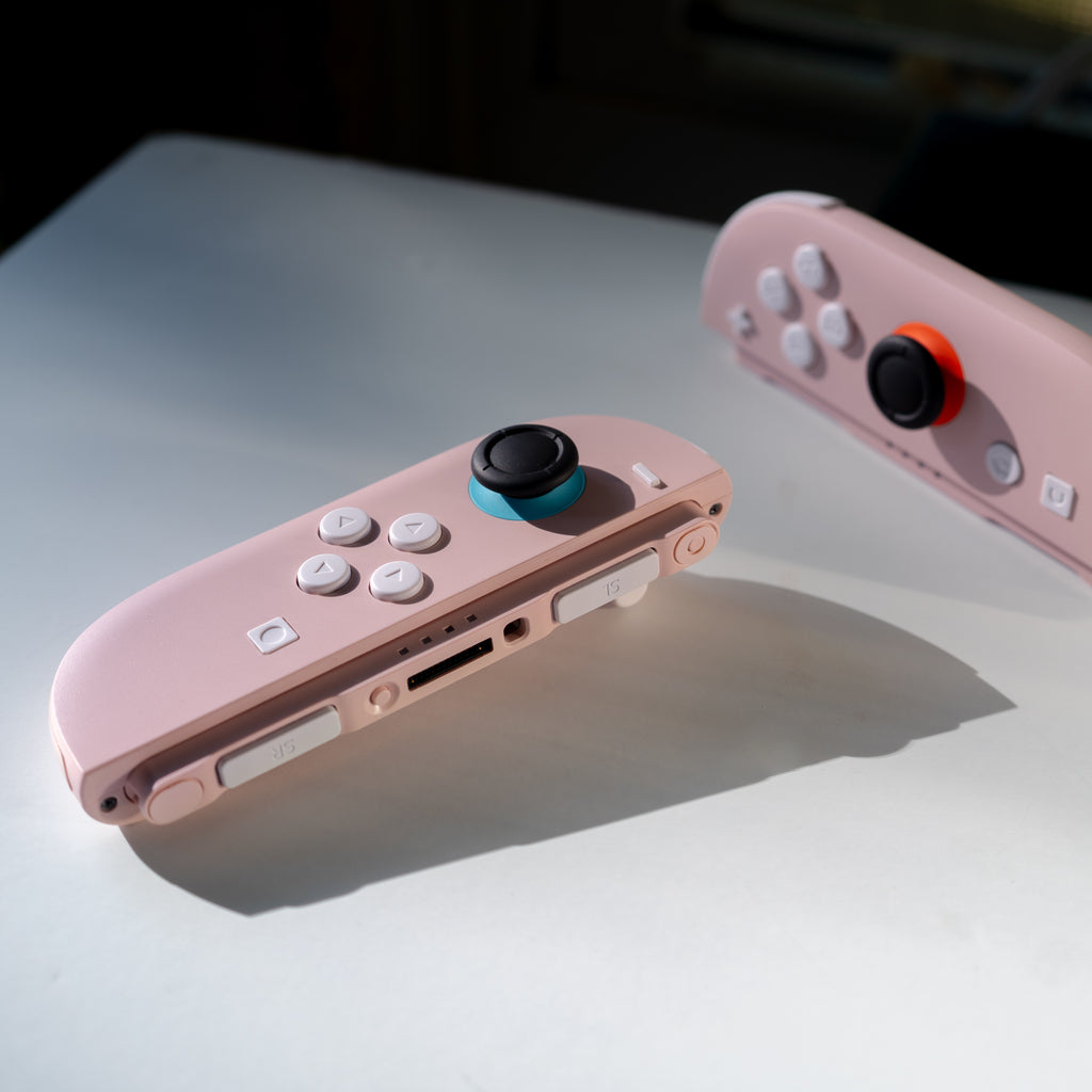 Pink Switch 2 Joy-Cons with custom white buttons.