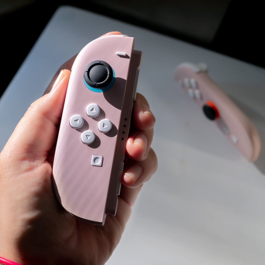 Pink Switch 2 Joy-Cons with custom white buttons.