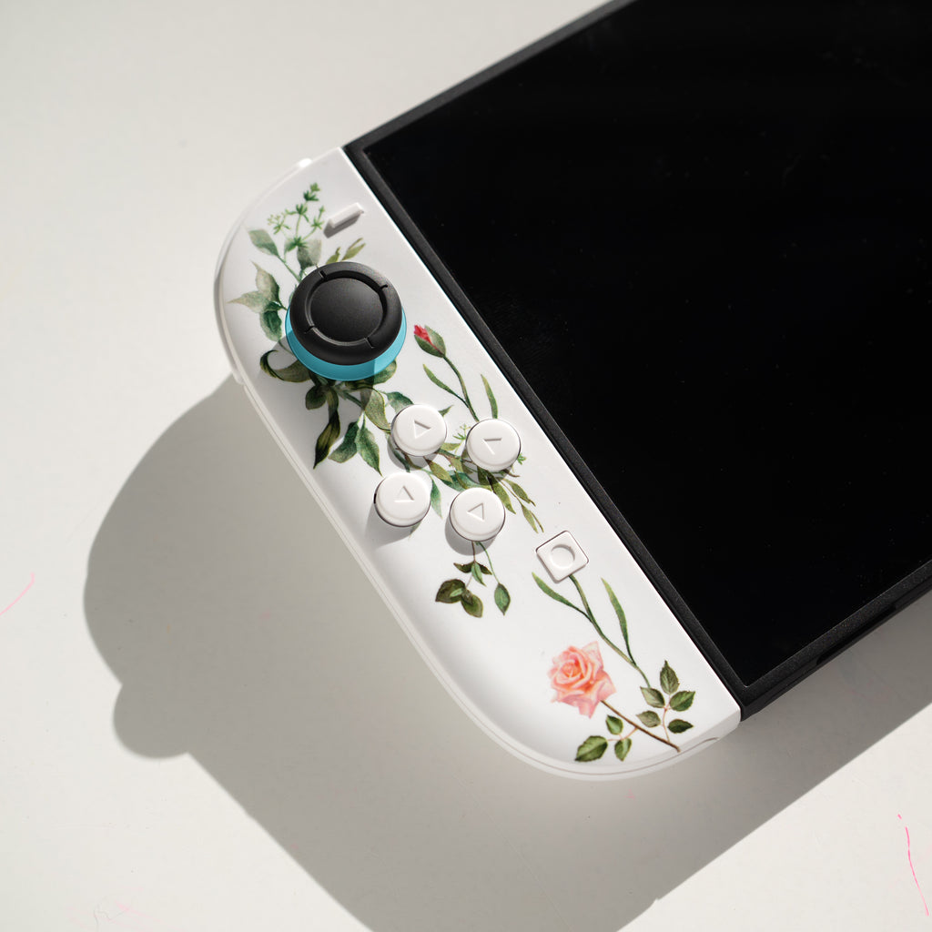Custom Switch 2 Joy-Cons with a floral print and custom white buttons.