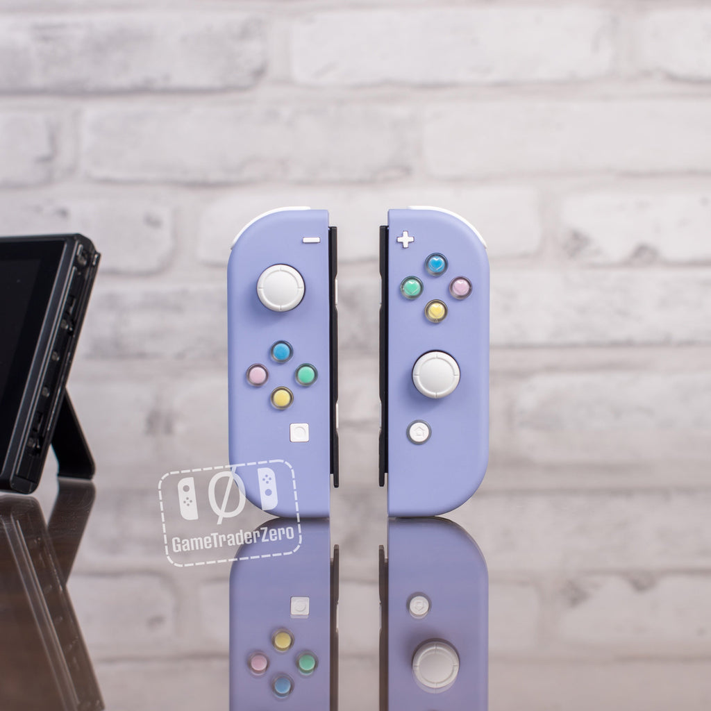 Violet joycons with pastel colored buttons.