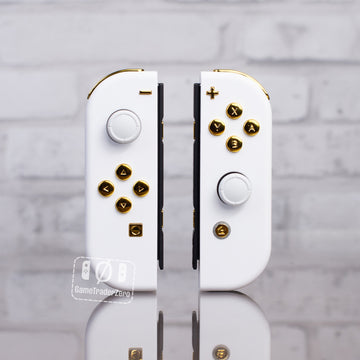 White Joy-Cons with gold chrome buttons.